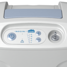 Close-up of the Inogen At Home control panel showing the power button, alarm indicator, flow settings 1 to 5, and the oxygen output port