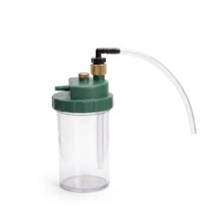 Humidifier connector tube screwed onto the brass inlet of an oxygen humidifier bottle; the bottle is shown for context and is not included